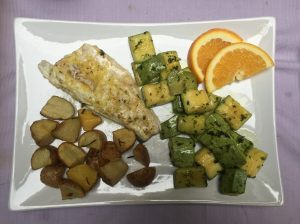 Branzino agli agrumi con patate e zucchine